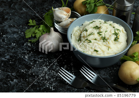 Concept of tasty eating with mashed potatoes on black smokey table 85196779