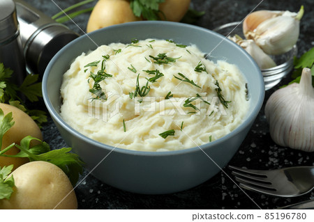 Concept of tasty eating with mashed potatoes on black smokey table 85196780