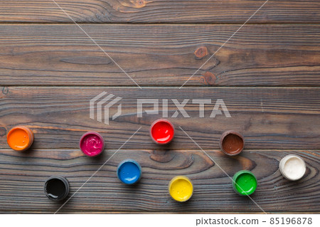 jars with gouache of different colors on Colored background. hobby painting. Top view with empty space. workplace for creativity. home teaching concept drawing jars with gouache of different colors on Colored background. hobby painting. Top view with empty space. workplace for creativity. home teaching concept drawing 85196878