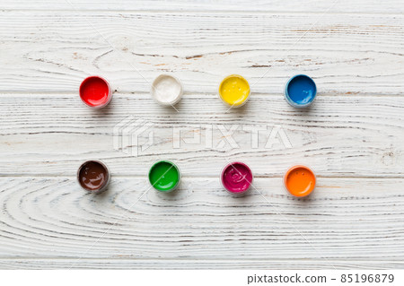jars with gouache of different colors on Colored background. hobby painting. Top view with empty space. workplace for creativity. home teaching concept drawing jars with gouache of different colors on Colored background. hobby painting. Top view with empty space. workplace for creativity. home teaching concept drawing 85196879