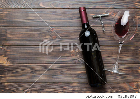 Flat lay composition with corkscrew, bottle of wine and elegant glass on colored table. Flat lay, top view wth copy space Flat lay composition with corkscrew, bottle of wine and elegant glass on colored table. Flat lay, top view wth copy space 85196898