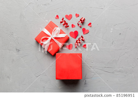 Happy valentines day opened heart shape gift box with small hearts, on colored background, valentines day card - top view concept Happy valentines day opened heart shape gift box with small hearts, on colored background, valentines day card - top view concept 85196951