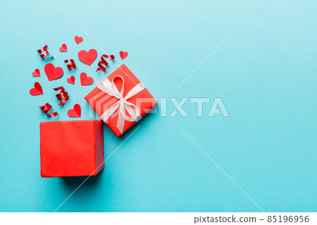 Happy valentines day opened heart shape gift box with small hearts, on colored background, valentines day card - top view concept Happy valentines day opened heart shape gift box with small hearts, on colored background, valentines day card - top view concept 85196956
