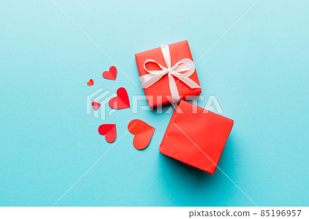 Happy valentines day opened heart shape gift box with small hearts, on colored background, valentines day card - top view concept Happy valentines day opened heart shape gift box with small hearts, on colored background, valentines day card - top view concept 85196957
