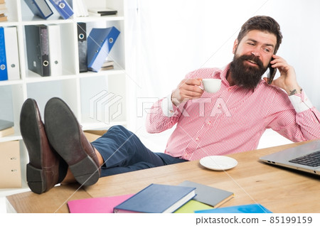Happy hipster talk on smartphone drinking tea in modern office, conversation 85199159