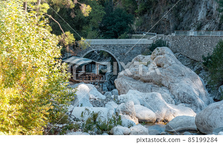 diner gazebo for tourists next to the ancient Roman bridge over a shady gorge in the Kesme Bogazi canyon, Turkey diner gazebo for tourists next to the ancient Roman bridge over a shady gorge in the Kesme Bogazi canyon, Turkey 85199284