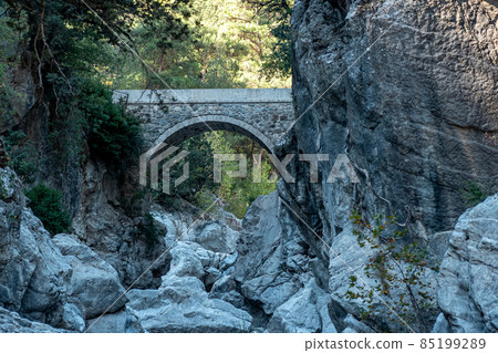 ancient Roman bridge over a shady gorge in the Kesme Bogazi canyon, Turkey ancient Roman bridge over a shady gorge in the Kesme Bogazi canyon, Turkey 85199289