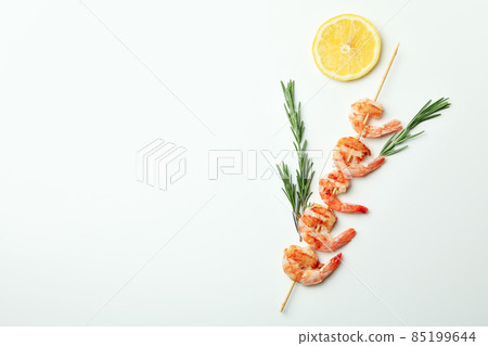 Tasty grilled shrimps skewer on white background Tasty grilled shrimps skewer on white background 85199644