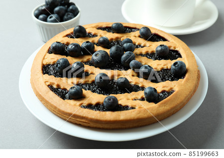 Concept of delicious breakfast with blueberry pie on gray background Concept of delicious breakfast with blueberry pie on gray background 85199663