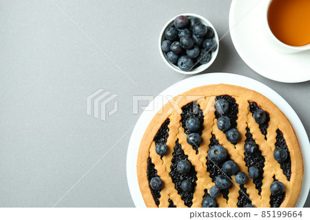 Concept of delicious breakfast with blueberry pie on gray background Concept of delicious breakfast with blueberry pie on gray background 85199664