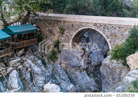 diner gazebo for tourists next to the ancient Roman bridge over a shady gorge in the Kesme Bogazi canyon, Turkey diner gazebo for tourists next to the ancient Roman bridge over a shady gorge in the Kesme Bogazi canyon, Turkey 85200339