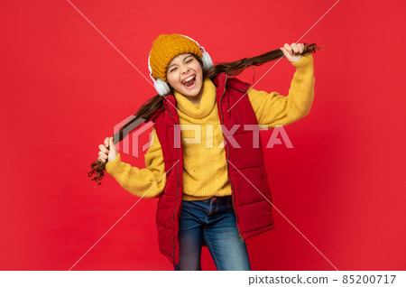 shouting kid in hat listen music in earphones holding hair, fun shouting kid in hat listen music in earphones holding hair, fun 85200717