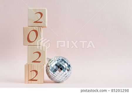 Wooden cubes pyramid with new year numbers and shining disco ball Wooden cubes pyramid with new year numbers and shining disco ball 85201298