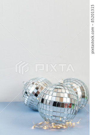silver disco ball on blue background, greeting card wallpaper template with empty space for text silver disco ball on blue background, greeting card wallpaper template with empty space for text 85201315