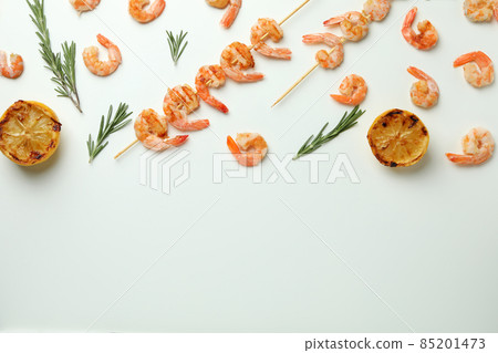 Tasty grilled shrimps and ingredients on white background Tasty grilled shrimps and ingredients on white background 85201473