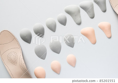 Orthopedic insoles on a white background. Treatment and prevention of flat feet and foot diseases. Foot care, foot comfort. Wear comfortable shoes. 85201551