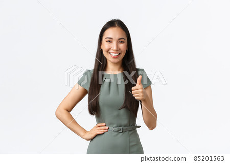 Small business owners, women entrepreneurs concept. Satisfied smiling asian female team leader praising great job, showing thumbs-up in approval, like result, white background 85201563