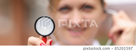 Smiling female doctor holding medical stethoscope closeup Smiling female doctor holding medical stethoscope closeup 85201597