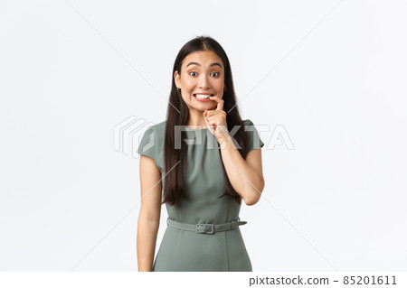 Small business owners, women entrepreneurs concept. Tempting and excited cute asian woman biting finger and looking with desire at something in store, going on shopping, want buy something Small business owners, women entrepreneurs concept. Tempting and excited cute asian woman biting finger and looking with desire at something in store, going on shopping, want buy something 85201611