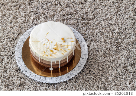 Delicious homemade chocolate marble birthday cake decorated with colorful stripes 85201818