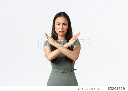 Small business owners, women entrepreneurs concept. Disappointed serious-looking businesswoman, CEO showing cross gesture to stop, disagree and reject offer, standing white background 85201819