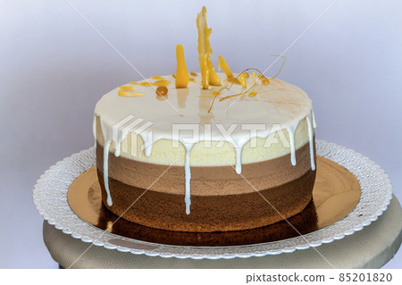 Delicious homemade chocolate marble birthday cake decorated with colorful stripes 85201820