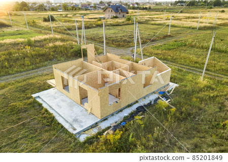 Construction of new and modern modular house. Walls made from composite wooden sip panels with styrofoam insulation inside. Building new frame of energy efficient home concept. Construction of new and modern modular house. Walls made from composite wooden sip panels with styrofoam insulation inside. Building new frame of energy efficient home concept. 85201849