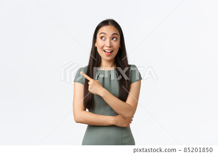 Small business owners, women entrepreneurs concept. Excited happy asian woman in dress pointing finger upper left corner and looking with amused smile, found excellent store good prices Small business owners, women entrepreneurs concept. Excited happy asian woman in dress pointing finger upper left corner and looking with amused smile, found excellent store good prices 85201850
