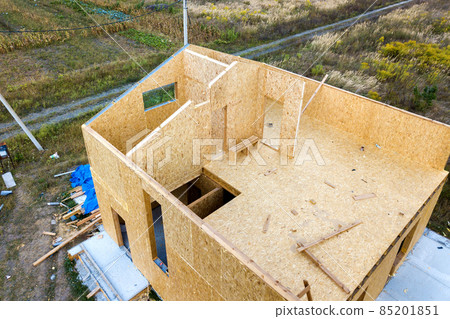 Construction of new and modern modular house. Walls made from composite wooden sip panels with styrofoam insulation inside. Building new frame of energy efficient home concept. Construction of new and modern modular house. Walls made from composite wooden sip panels with styrofoam insulation inside. Building new frame of energy efficient home concept. 85201851