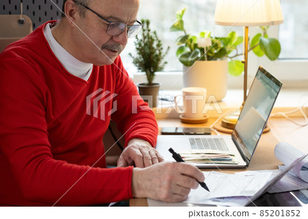 Senior man with eyeglasses counting money from retirement and control finance Senior man with eyeglasses counting money from retirement and control finance 85201852