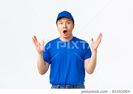 Surprised and excited courier in blue uniform react to awesome news, big announcement in mail company. Impressed delivery guy shaking raised hands and gasping amazed, white background Surprised and excited courier in blue uniform react to awesome news, big announcement in mail company. Impressed delivery guy shaking raised hands and gasping amazed, white background 85202064