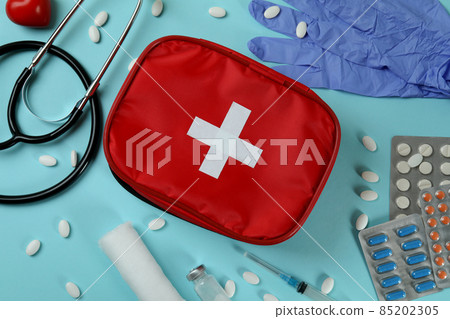 First aid medical kit on blue background 85202305