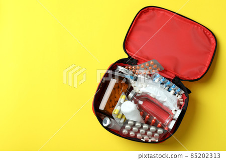First aid medical kit on yellow background First aid medical kit on yellow background 85202313