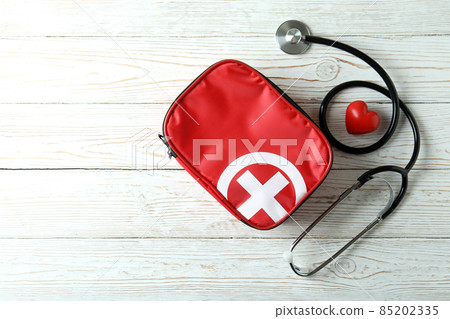 First aid medical kit on white wooden table First aid medical kit on white wooden table 85202335