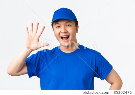 Online shopping, fast shipping, employees and home delivery concept. Confident smiling asian male courier with braces, wearing blue uniform, showing number five, white background 85202476