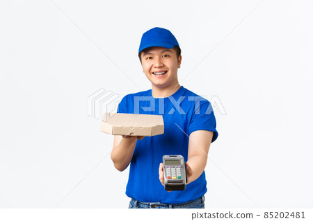 Contactless shopping, payment and delivery concept. Cheerful friendly, smiling asian courier in blue uniform bring order to client home, handing pizza box and POS terminal, white background Contactless shopping, payment and delivery concept. Cheerful friendly, smiling asian courier in blue uniform bring order to client home, handing pizza box and POS terminal, white background 85202481