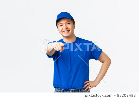 Cheerful friendly asian courier with braces, wearing blue uniform, searching employees for company, pointing finger at camera as choosing you, picking someone, standing white background Cheerful friendly asian courier with braces, wearing blue uniform, searching employees for company, pointing finger at camera as choosing you, picking someone, standing white background 85202488