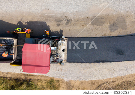 Aerial view of new road construction with asphalt laying machinery at work. 85202584