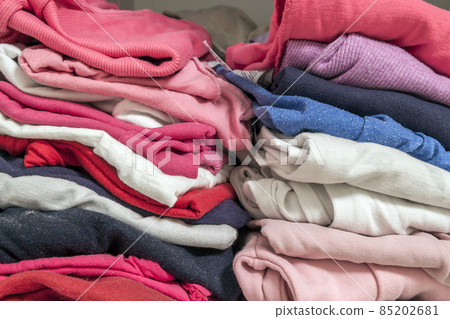 A stack of knitted warm woolen clothes in wardrobe close up A stack of knitted warm woolen clothes in wardrobe close up 85202681