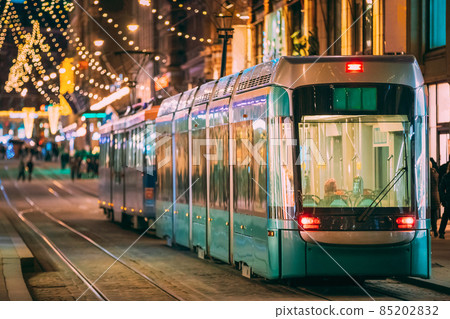 Helsinki, Finland. Tram Departs From Stop On Aleksanterinkatu Street. Night Evening Christmas Xmas New Year Festive Illumination On Street. Beautiful Street Decorations During Winter Holidays 85202832