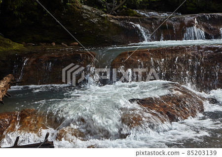 River with hot spring not far from volcano  Mendeleev on  Kunashir Island. Kuril Islands Russia 85203139