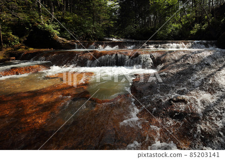 River with hot spring not far from volcano  Mendeleev on  Kunashir Island. Kuril Islands Russia 85203141