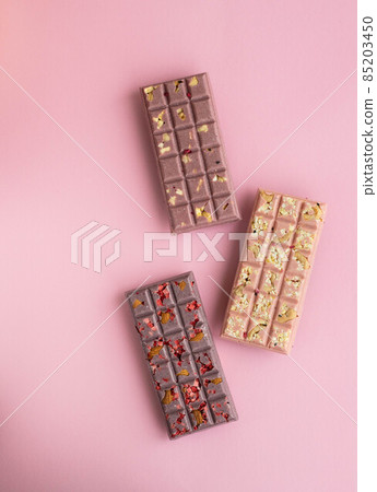 Closeup set of chokolate bars on pink background 85203450