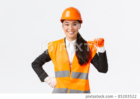 Professional and talented confident smiling asian female engineer, construction architect in safety helmet and glasses, pointing at herself proud, promote own abilities and skills, white background Professional and talented confident smiling asian female engineer, construction architect in safety helmet and glasses, pointing at herself proud, promote own abilities and skills, white background 85203522
