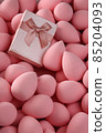 beauty background a bunch of pink gentle makeup sponges and a pink gift vertical orientation 85204093