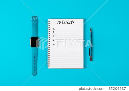 To do list banner. A watch, pencil and modern notebook isolated on blue background from above. Planning and design concept. Top view, flat lay, copy space. 85204287