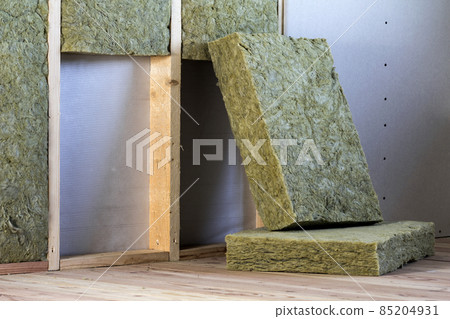 Wooden frame for future walls with drywall plates insulated with rock wool and fiberglass insulation staff for cold barrier. Comfortable warm home, economy, construction and renovation concept. 85204931