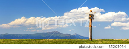 Tourist paths directions shown on a traditional direction sign in mountains. Tourist paths directions shown on a traditional direction sign in mountains. 85205034