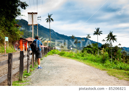 Tourist taking pictures at the beautiful Valle de Cocora located in Salento at the Quindio region in Colombia 85206821