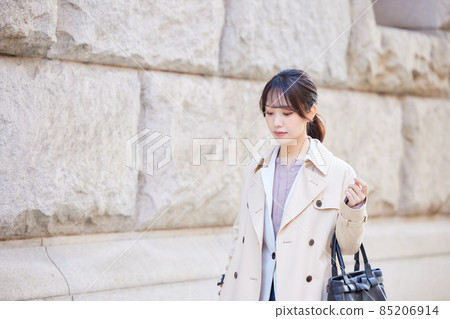 A woman walking in the city at work A woman walking in the city at work 85206914